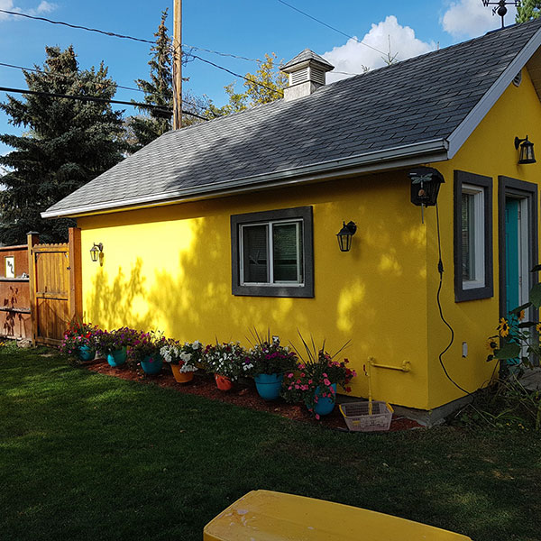 Bumblebee Stucco yellow house with lawn